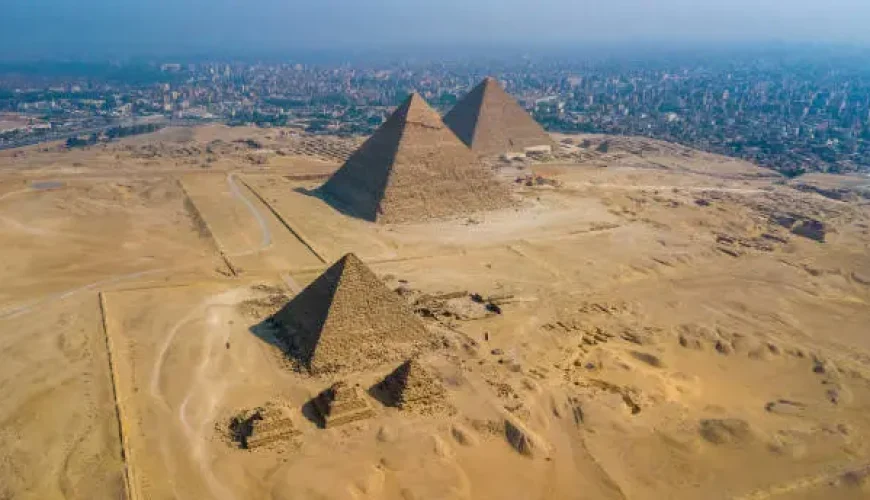 Tourists exploring the Great Pyramids of Giza in Cairo Egypt during autumn