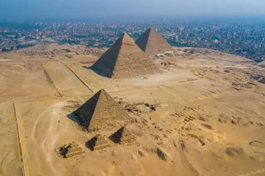 Tourists exploring the Great Pyramids of Giza in Cairo Egypt during autumn