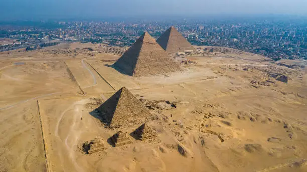 Tourists exploring the Great Pyramids of Giza in Cairo Egypt during autumn